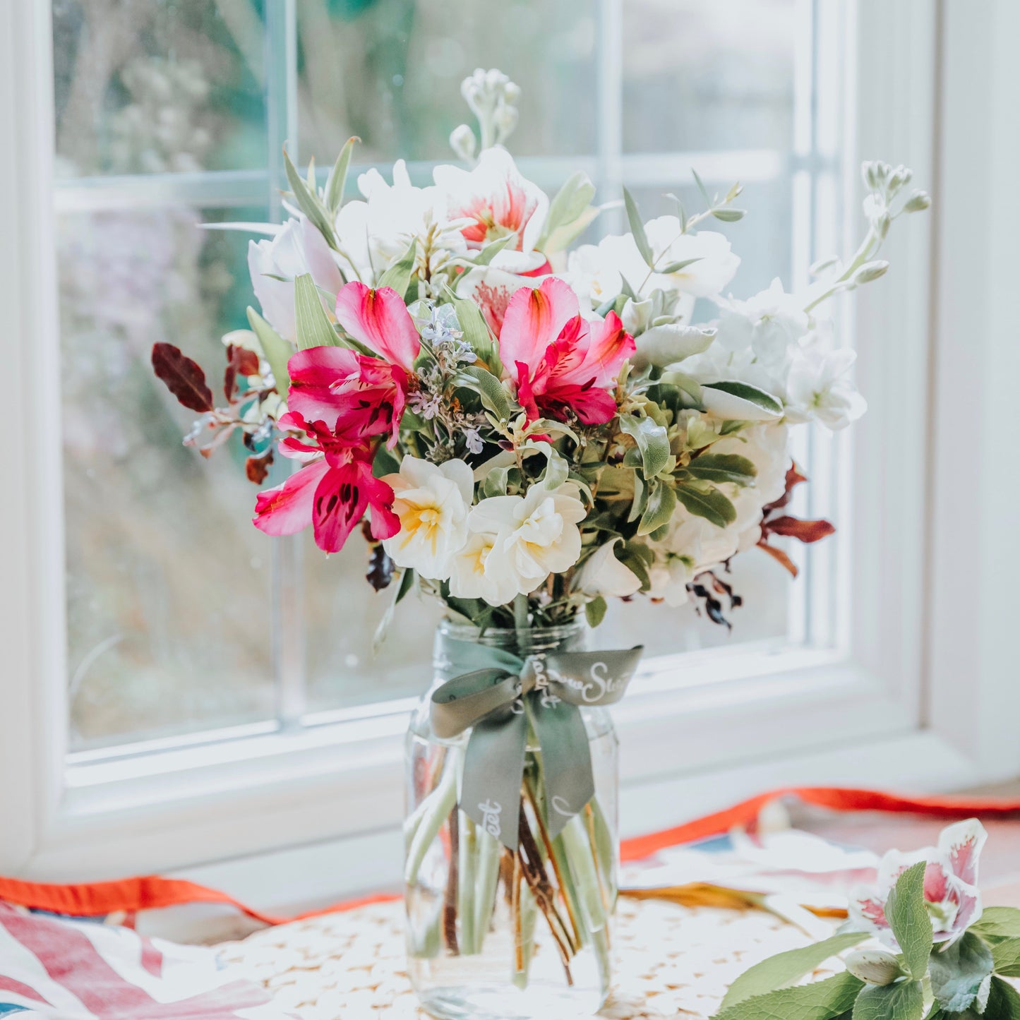 British seasonal flower posy flower subscription service. Mini Spring bouquet featuring fragrant narcissi, alstroemeria and pretty scented stocks in a recycled content glass jar.