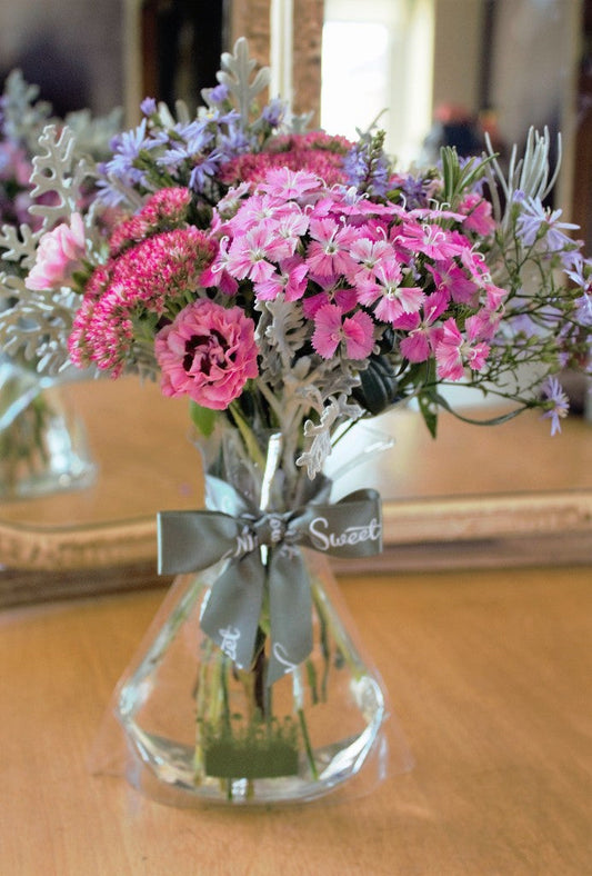 MeadowSweet seasonal posy with British indoor-grown sweet williams, pinks, asters, sedum, senecio, curry plant and rosemary.