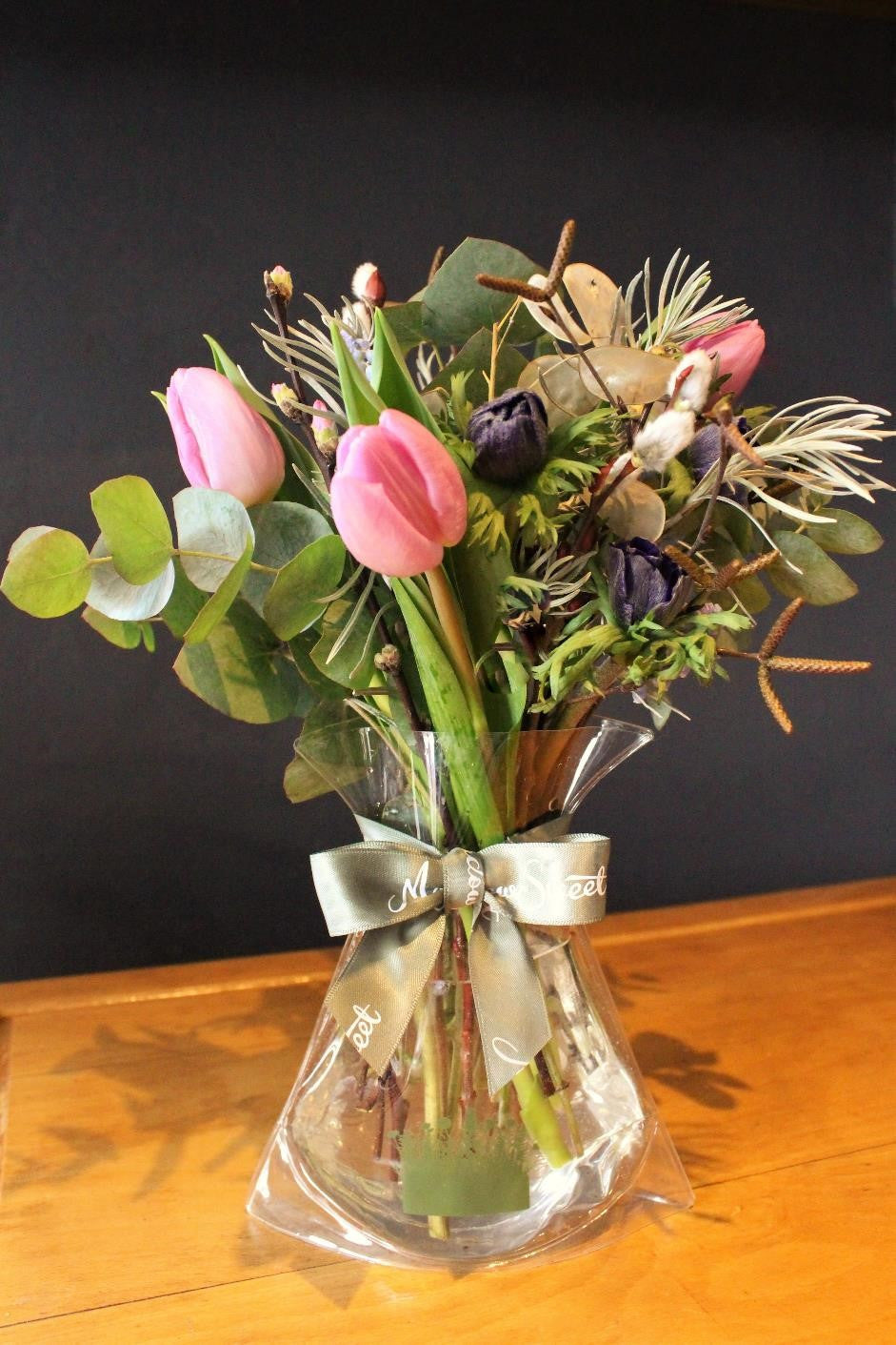 MeadowSweet seasonal posy with Pink tulips, blue anemones, silver eucalyptus, pussy willow, birch catkins and curry plant. 