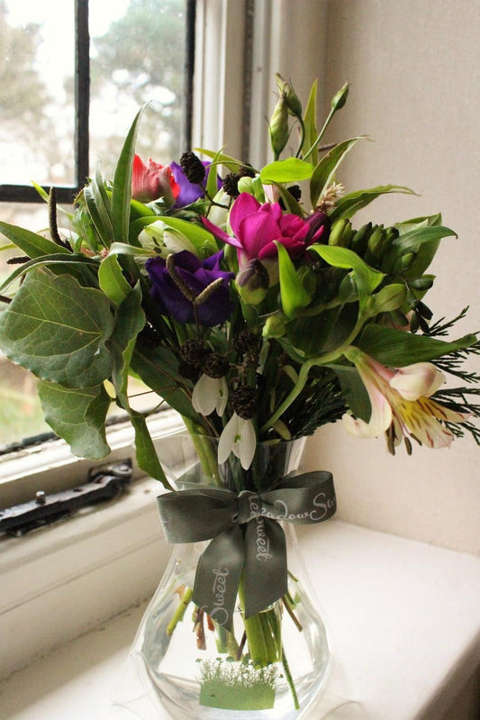MeadowSweet seasonal posy with Snowdrops, Anemones, Freesia, Lisianthus, Alstromeria, Rhododendron, Birch, Alder, Sarcococca, Epimedium, Cupressus, Lonicera nitida.
