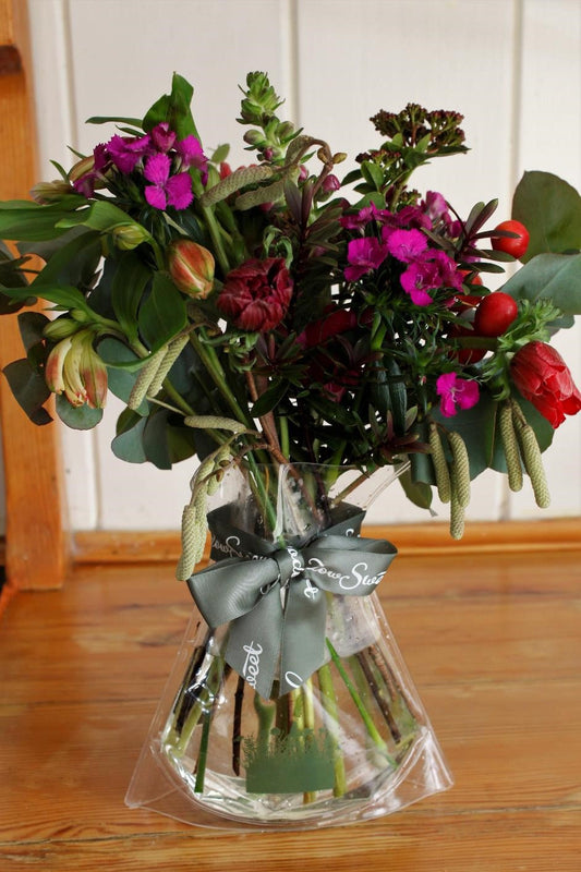 MeadowSweet seasonal posy with sweet williams, snapdragons, anemones, hebe, pink-flowering viburnum, alstromeria, crab apples, hazel catkins and silver-leafed eucalyptus.