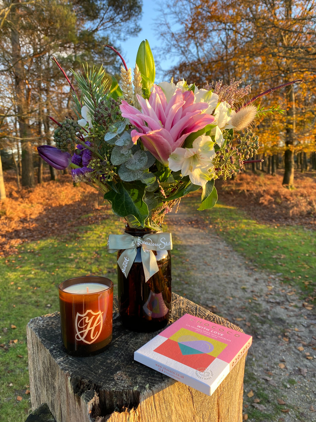 MeadowSweet British flower posy with Christmas scented candle and chocolate bar gifts photographed in the New Forest