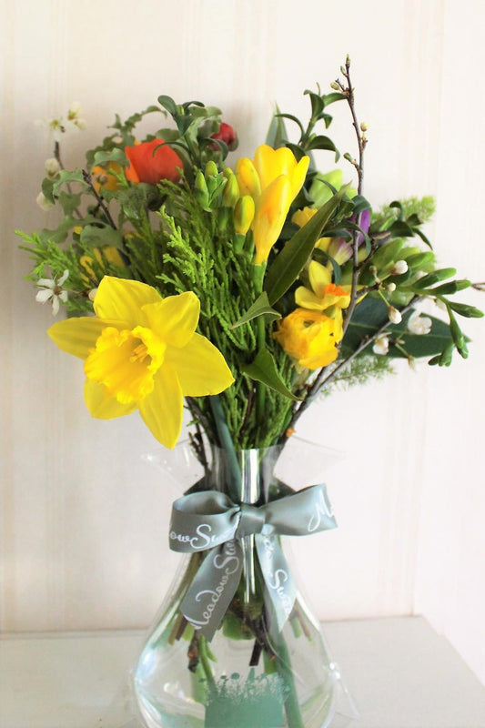 MeadowSweet March seasonal posy with Ranunculus, freesias, narcissi, daffodils, plum blossom, Portugual laurel, cupressus, flowering box, tree heather.