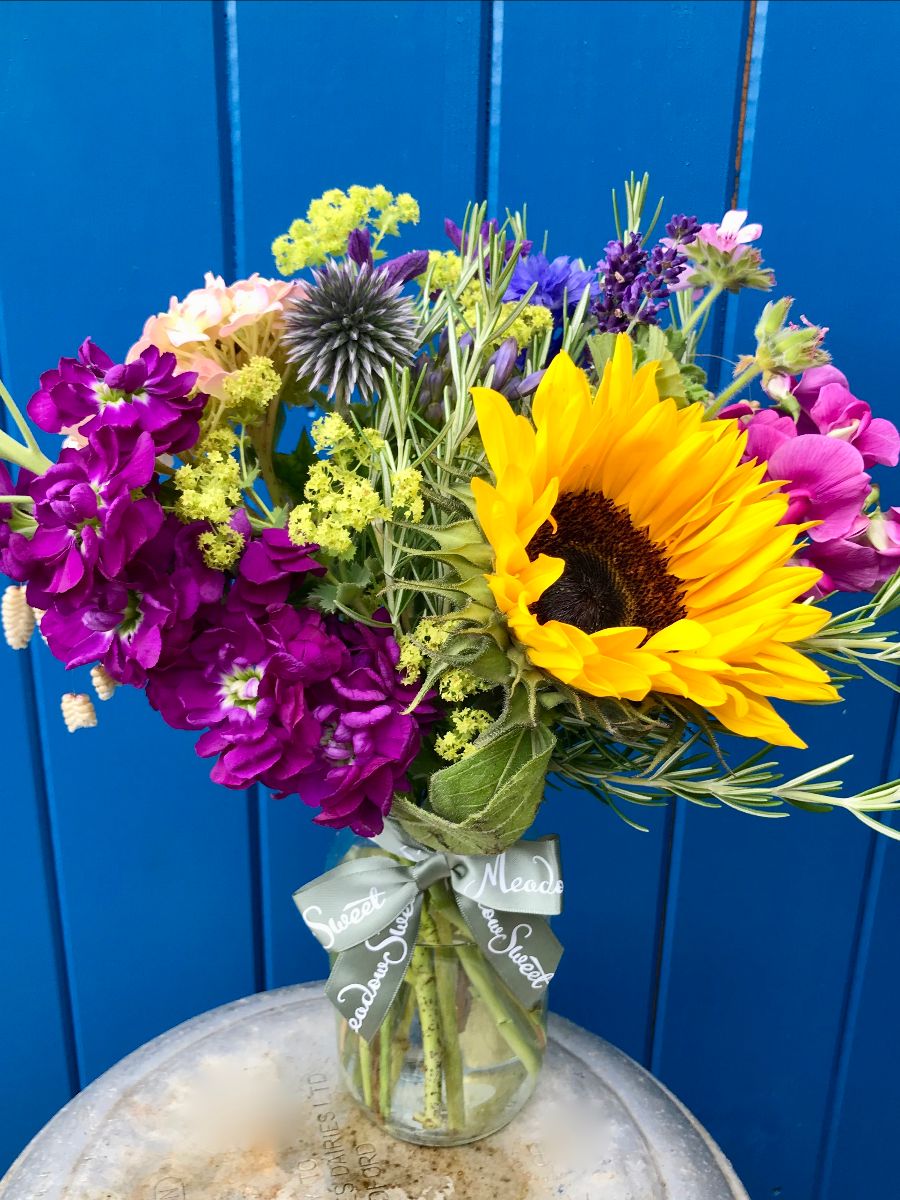 British grown summer flowers like scented stocks and sunflowers in glass MeadowSweet jar
