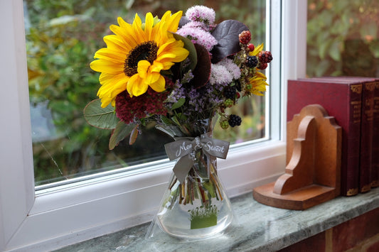 MeadowSweet seasonal posy with  hydrangea, sedum and blackberry mixed with rusty-tinted sunflowers, smoke-bush, ageratum and sea lavender.