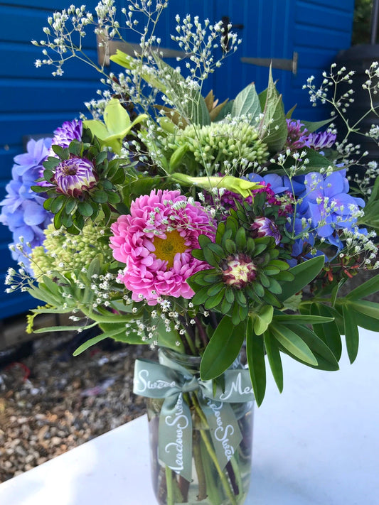British and homegrown pretty summer flowers in a jar