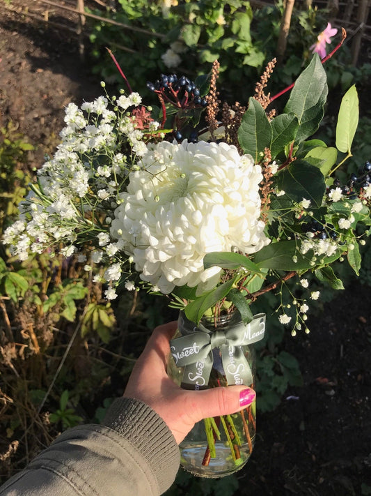 Winter British flower posy with snowball chrysanthemum and gypsophila