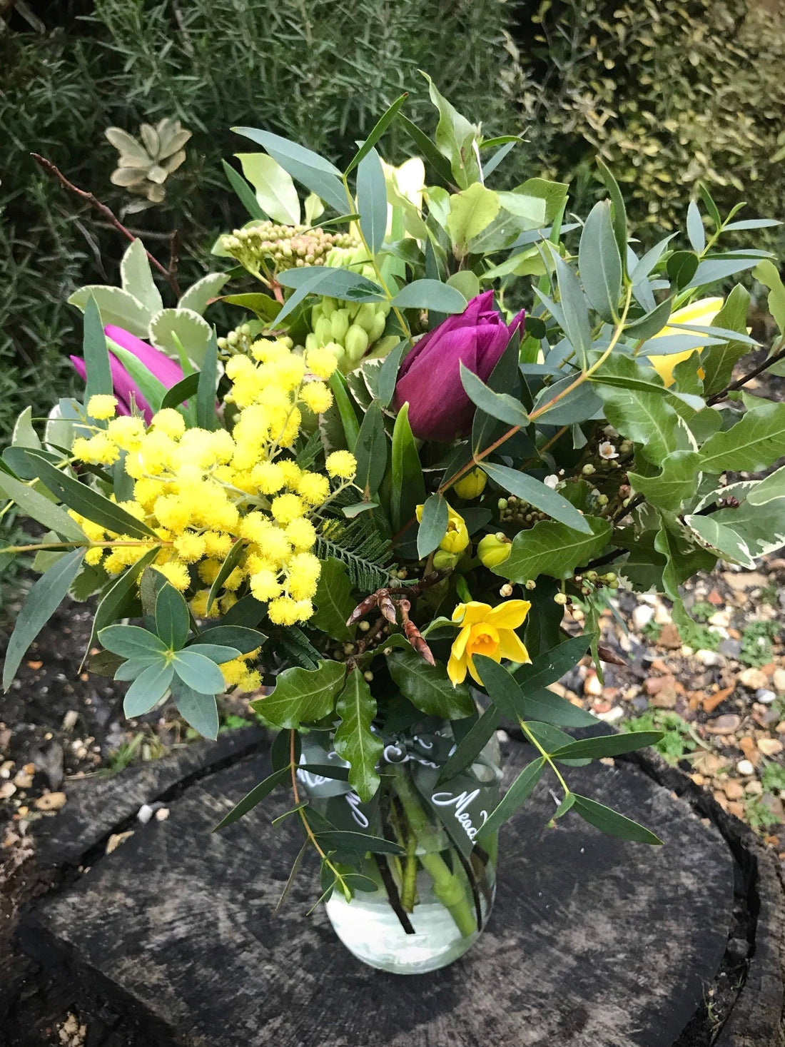 Homegrown mimosa and British tulip posy in a glass jar