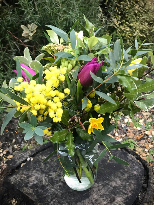 Homegrown mimosa and British tulip posy in a glass jar