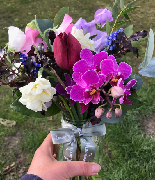 British orchids, sweet peas, tulips and muscari in this seasonal posy