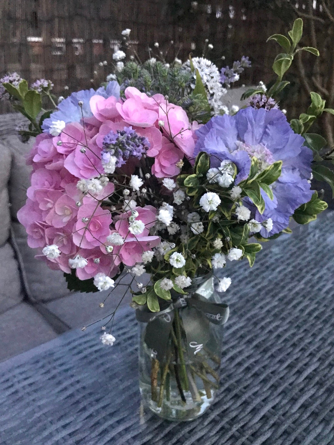 Homegrown summer flower posy in a glass jar