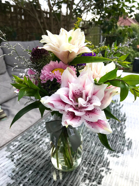 British grown roselilies and asters bouquet in a glass jar