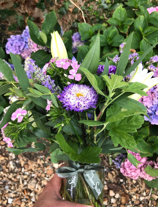 Pretty purple flowers in a glass jar