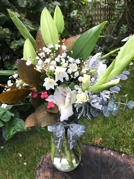 British grown lilies, spindle, gypsophila and gladioli in a glass jar