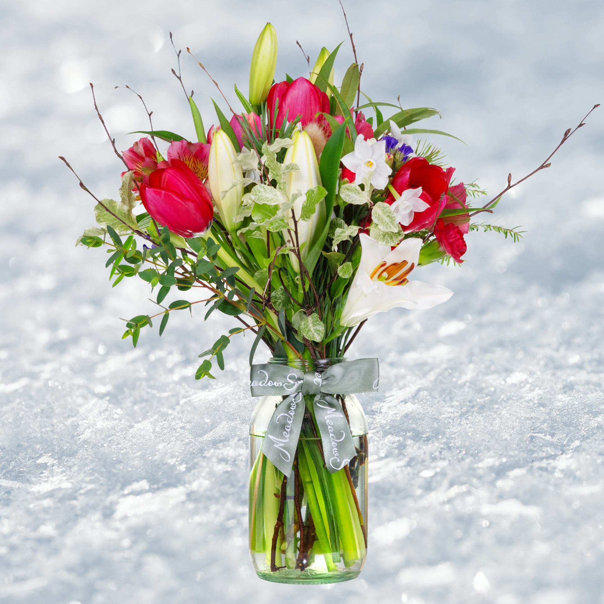 British Grown Winter Flower Posy with tulips lilies and paperwhites In Glass Jar with snowy backdrop